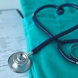 Doctors stethoscope on fold hospital sheets.