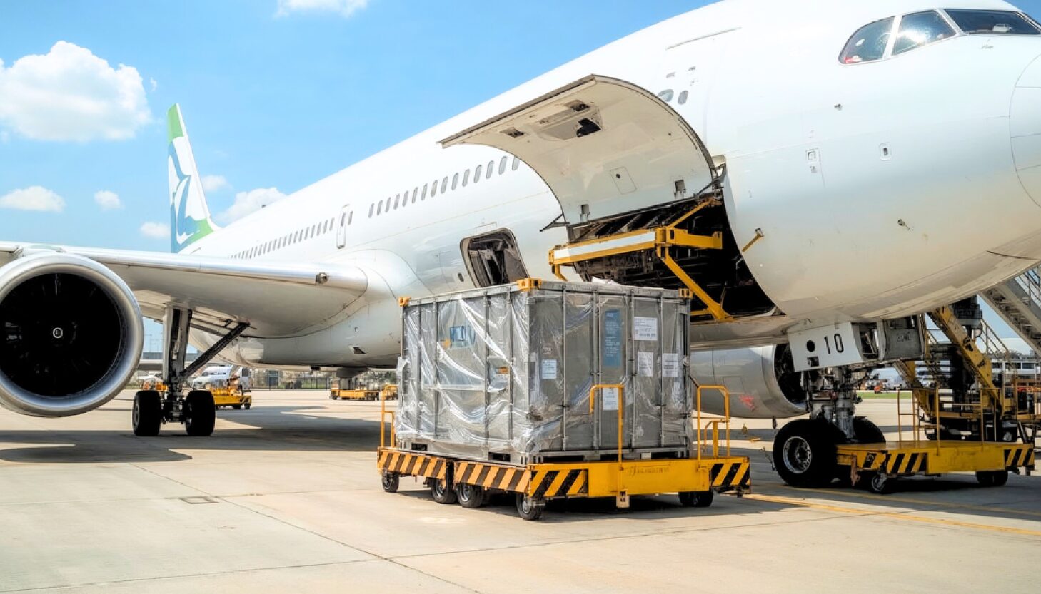 Freight being loaded onto aircraft for urgent Next Flight Out (NFO) air freight shipping.